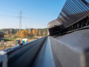Close-up view of a seamless gutter system, highlighting its long, smooth run and sleek finish.