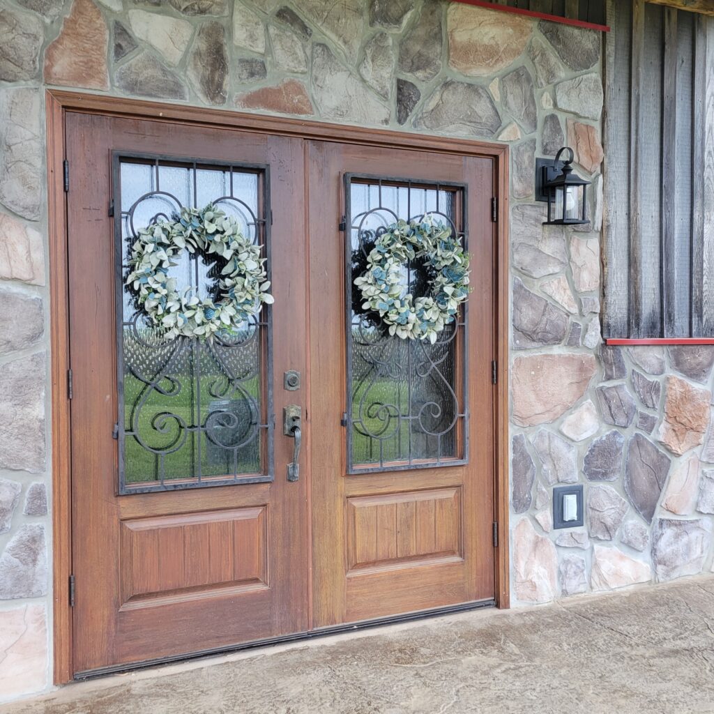 Fancy wooden doors mark the entrance into a barn built for special gatherings.